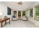 Bright sunroom with large windows, neutral flooring, and cozy seating area at 524 Heritage Vw, Indian Trail, NC 28079