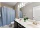 Bathroom featuring double vanity sinks, a walk-in shower behind a blue shower curtain and a mirror at 537 Lakeview Dr, Mcadenville, NC 28101