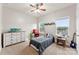 Neutral-toned bedroom featuring two windows, ceiling fan and carpet floors at 537 Lakeview Dr, Mcadenville, NC 28101