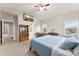 Bright bedroom featuring a ceiling fan, TV, dressing table and a view from two windows at 537 Lakeview Dr, Mcadenville, NC 28101