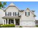 Charming two-story home featuring black shutters, a covered porch, and an attached two-car garage at 537 Lakeview Dr, Mcadenville, NC 28101