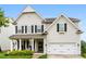Charming two-story home featuring black shutters, a covered porch, and an attached two-car garage at 537 Lakeview Dr, Mcadenville, NC 28101