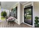 Inviting front porch with seating area and decorative 'hello' wreath on the front door at 537 Lakeview Dr, Mcadenville, NC 28101