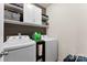 Organized laundry room with white washer and dryer, white cabinets and shelving at 537 Lakeview Dr, Mcadenville, NC 28101