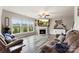 Bright living room featuring a fireplace, large windows, hardwood floors and neutral decor at 537 Lakeview Dr, Mcadenville, NC 28101