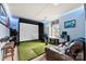 Recreation room with golf simulator, blue LED lighting, and comfortable seating area at 537 Lakeview Dr, Mcadenville, NC 28101