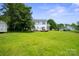 Large open backyard with lush green grass and a shed on the side of the house at 6516 Laurel Springs Ct, Charlotte, NC 28227