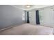 This bedroom features neutral walls, carpet and three windows providing natural light at 6516 Laurel Springs Ct, Charlotte, NC 28227