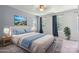 Bright staged bedroom featuring a large bed, hardwood floors, and natural light at 6516 Laurel Springs Ct, Charlotte, NC 28227