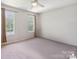This bedroom features neutral walls, carpet and two windows providing natural light at 6516 Laurel Springs Ct, Charlotte, NC 28227