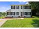 Charming two-story home with classic shutters and manicured lawn overlooking the serene lake at 6516 Laurel Springs Ct, Charlotte, NC 28227
