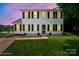 Charming two-story home with classic shutters and manicured lawn overlooking the serene lake at 6516 Laurel Springs Ct, Charlotte, NC 28227