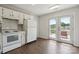 Bright kitchen features white cabinets, modern appliances, and a view of the lake at 6516 Laurel Springs Ct, Charlotte, NC 28227