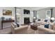 Staged living room showcases fireplace, hardwood floors, and plenty of seating for entertaining guests at 6516 Laurel Springs Ct, Charlotte, NC 28227