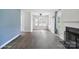 Hardwood flooring and a fireplace are showcased in this well-lit living room with dining space at 6516 Laurel Springs Ct, Charlotte, NC 28227