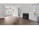 Inviting living room showcases hardwood floors, a cozy fireplace, and large windows offering outdoor views at 6516 Laurel Springs Ct, Charlotte, NC 28227