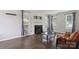 Spacious living room boasts a fireplace, hardwood floors, and multiple windows for ample natural light at 6516 Laurel Springs Ct, Charlotte, NC 28227