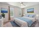 Bedroom with bed, blue accent pillows and rug, bedside table and art of a blue ocean scene at 6516 Laurel Springs Ct, Charlotte, NC 28227