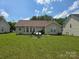 A spacious backyard with a well-maintained lawn, offering room for outdoor activities at 6902 Vernon Wood Ln, Charlotte, NC 28262