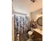Bathroom showcasing a shower, vanity, and convenient storage shelves at 6902 Vernon Wood Ln, Charlotte, NC 28262