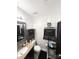 Cozy bathroom featuring a granite countertop, mirror, and essential amenities at 6902 Vernon Wood Ln, Charlotte, NC 28262