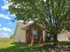 Charming home with brick and siding exterior, set against a blue sky and lush green lawn at 6902 Vernon Wood Ln, Charlotte, NC 28262