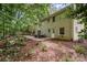 Spacious backyard with a well-maintained lawn and a patio area, providing ample space for outdoor activities and relaxation at 6935 Woodstock Dr, Charlotte, NC 28210