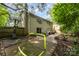 Large backyard features a basketball hoop, soccer goal, brick patio, and lush greenery at 6935 Woodstock Dr, Charlotte, NC 28210