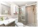 Bathroom featuring an updated shower with glass door, mosaic tile accent, and updated vanity with white sink at 6935 Woodstock Dr, Charlotte, NC 28210