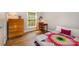 Cozy bedroom with hardwood floors, a bright window, and a classic desk at 6935 Woodstock Dr, Charlotte, NC 28210