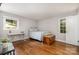 Neutral bedroom with hardwood floors and two bright windows at 6935 Woodstock Dr, Charlotte, NC 28210