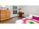 Bedroom with hardwood flooring, neutral paint, and a brightly lit window at 6935 Woodstock Dr, Charlotte, NC 28210