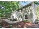 Charming backyard patio area with outdoor seating, fire pit, and lush landscaping around the house's exterior at 6935 Woodstock Dr, Charlotte, NC 28210