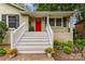 Inviting front porch with white railings and a bright red door at 6935 Woodstock Dr, Charlotte, NC 28210