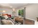 Cozy living room with sliding glass doors to the outdoor patio, creating a seamless indoor-outdoor living experience at 6935 Woodstock Dr, Charlotte, NC 28210