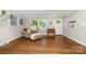 Living room features hardwood floors, neutral paint, and a sunny window at 6935 Woodstock Dr, Charlotte, NC 28210