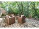 Outdoor patio area featuring comfortable seating around a fire pit, perfect for enjoying the serene backyard setting at 6935 Woodstock Dr, Charlotte, NC 28210