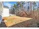 Spacious backyard with a white fence, a wooded area, and ample room for outdoor activities and relaxation at 7214 Fox Point Dr, Charlotte, NC 28269
