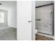 Bathroom doorway showcasing tiled shower with glass door at 7214 Fox Point Dr, Charlotte, NC 28269