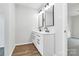 Modern bathroom featuring double vanity, sleek fixtures, and a wood-look floor at 7214 Fox Point Dr, Charlotte, NC 28269