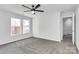 A light-filled bedroom features a ceiling fan and multiple windows at 7214 Fox Point Dr, Charlotte, NC 28269