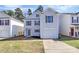 Charming two-story home featuring light siding, green shutters, a one car garage, and a well-manicured front lawn at 7214 Fox Point Dr, Charlotte, NC 28269