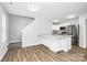 Open concept kitchen featuring an island with granite countertops, stainless appliances and luxury vinyl plank floors at 7214 Fox Point Dr, Charlotte, NC 28269
