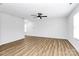 Bright living room featuring luxury vinyl plank flooring, a modern ceiling fan and freshly painted walls at 7214 Fox Point Dr, Charlotte, NC 28269