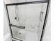 Modern bathroom shower with sleek black frame, geometric floor, and tile walls at 7214 Fox Point Dr, Charlotte, NC 28269