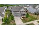Well-kept home boasts lawn, landscaping, and an attached two-car garage in a Gathering-friendly neighborhood at 7263 Waterwheel Sw St, Concord, NC 28025