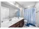 Well-lit bathroom features a double vanity, a shower, and a coordinated color scheme at 7263 Waterwheel Sw St, Concord, NC 28025