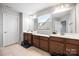 Bright bathroom featuring double sink vanity with sleek countertops and warm-toned cabinetry at 7263 Waterwheel Sw St, Concord, NC 28025