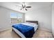 Comfortable bedroom featuring a ceiling fan and bright window views at 7263 Waterwheel Sw St, Concord, NC 28025
