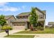 Traditional two-story home with green lawn, lush landscaping, and two car garage at 7263 Waterwheel Sw St, Concord, NC 28025